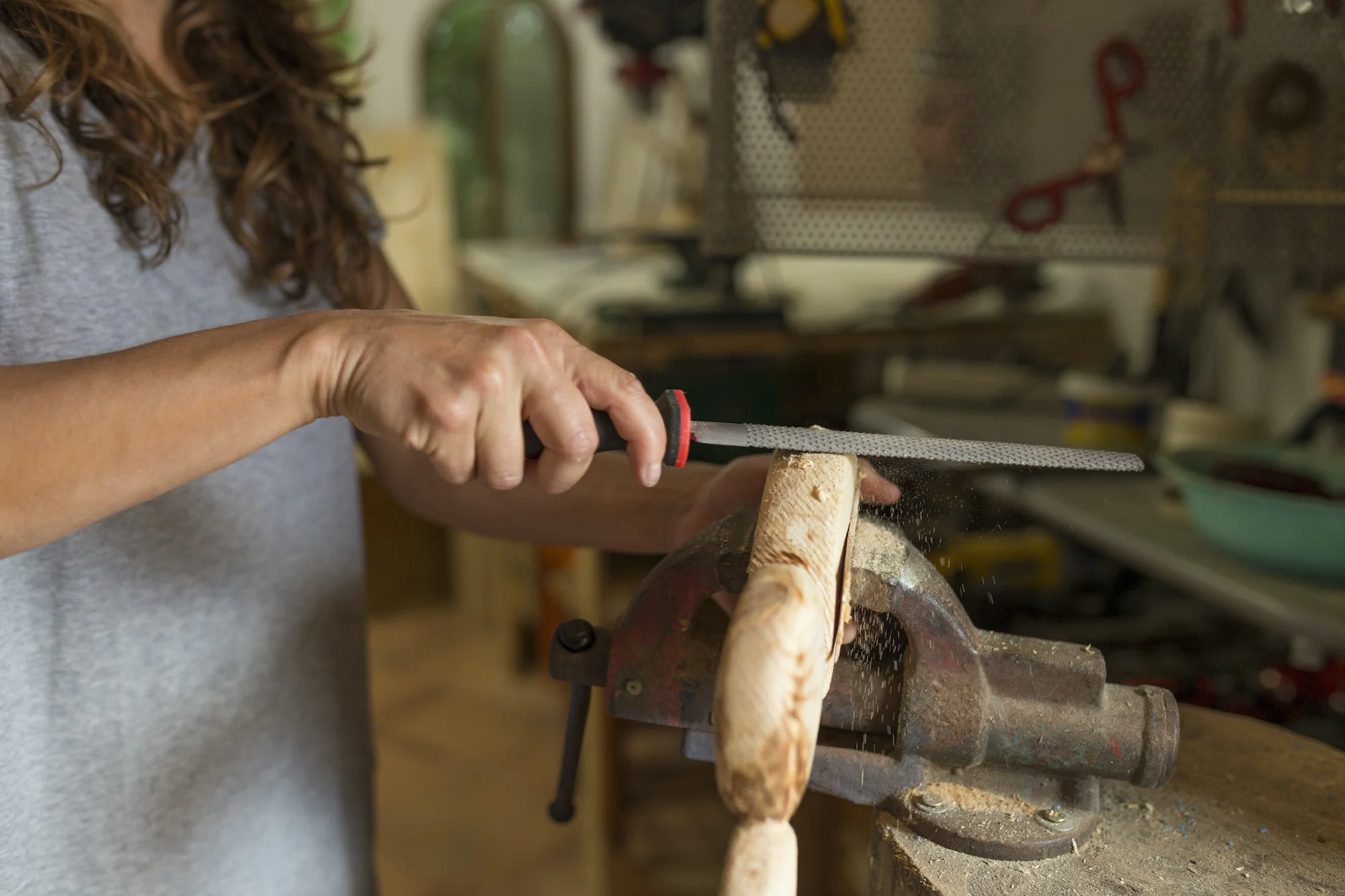 Bois Et Outils -Bois Et Outils craftswoman filing a piece of wood in her workshop